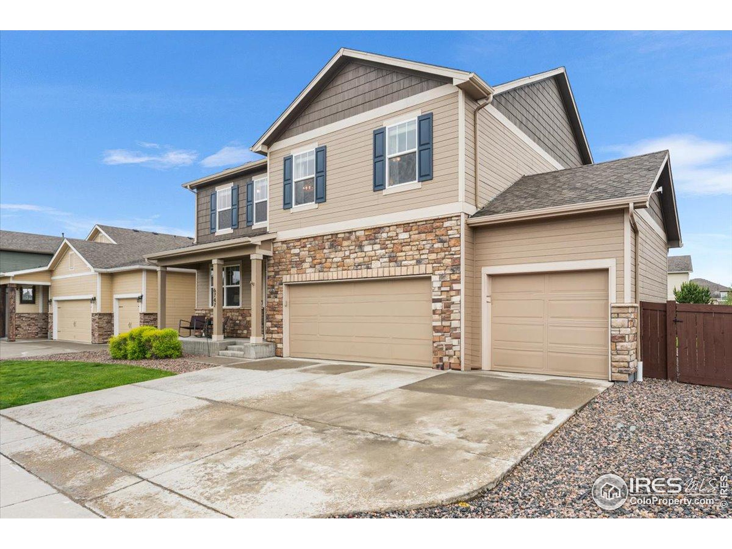 6747 Grainery Road Timnath, CO 80547 - Photo 32 of 42 a front view of a house with a yard and garage