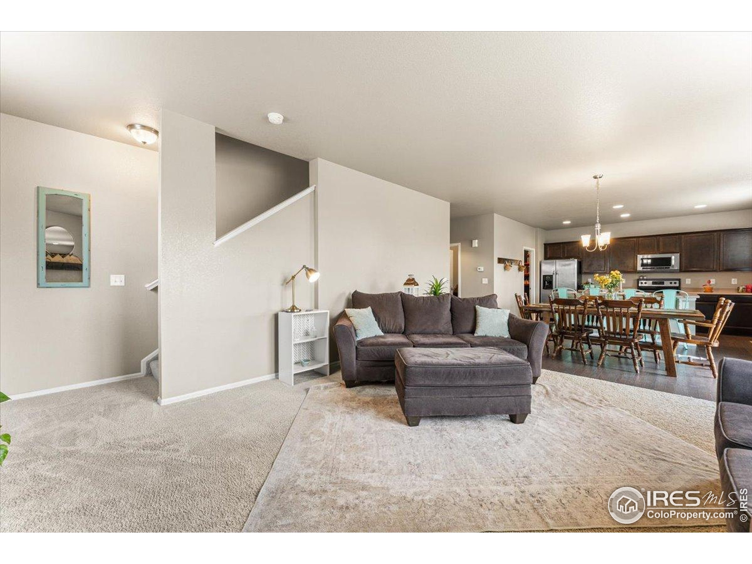 6747 Grainery Road Timnath, CO 80547 - Photo 8 of 42 a living room with lots of furniture and a wooden floor