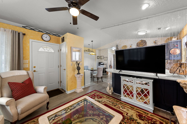 1225 North Dixie Downs Road, Unit 161 St. George, UT 84770 - Photo 5 of 21 Entryway with a paneled door featuring an arched window, wood-finish flooring, and a ceiling fan with integrated lighting