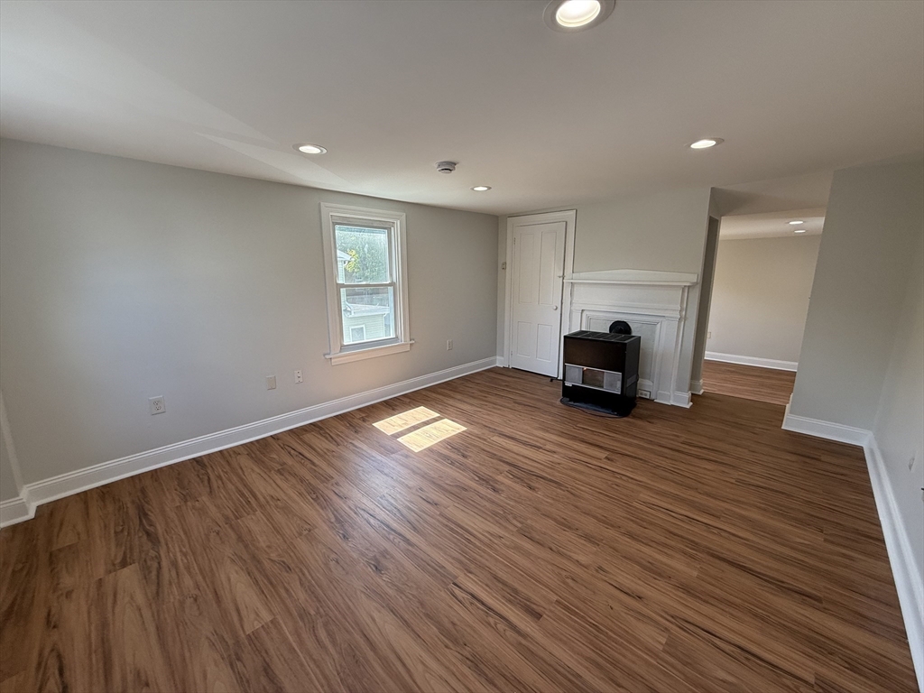3 Mill Street Shirley, MA 01464 - Photo 20 of 27 an empty room with wooden floor and windows