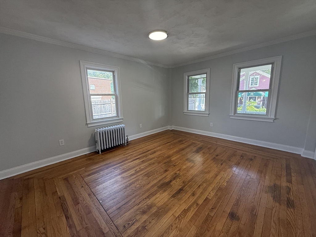 3 Mill Street Shirley, MA 01464 - Photo 4 of 27 a view of an empty room with wooden floor and a window
