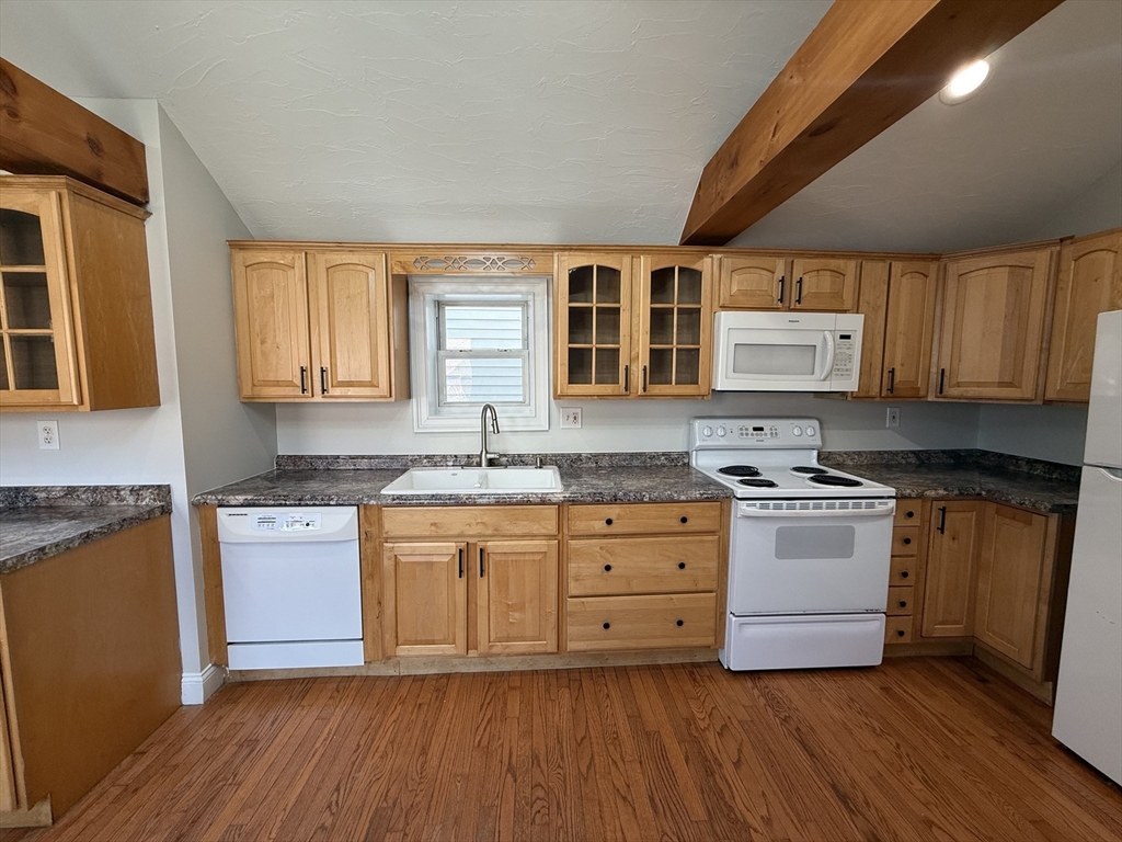 3 Mill Street Shirley, MA 01464 - Photo 9 of 27 a kitchen with granite countertop wooden floors and white cabinets