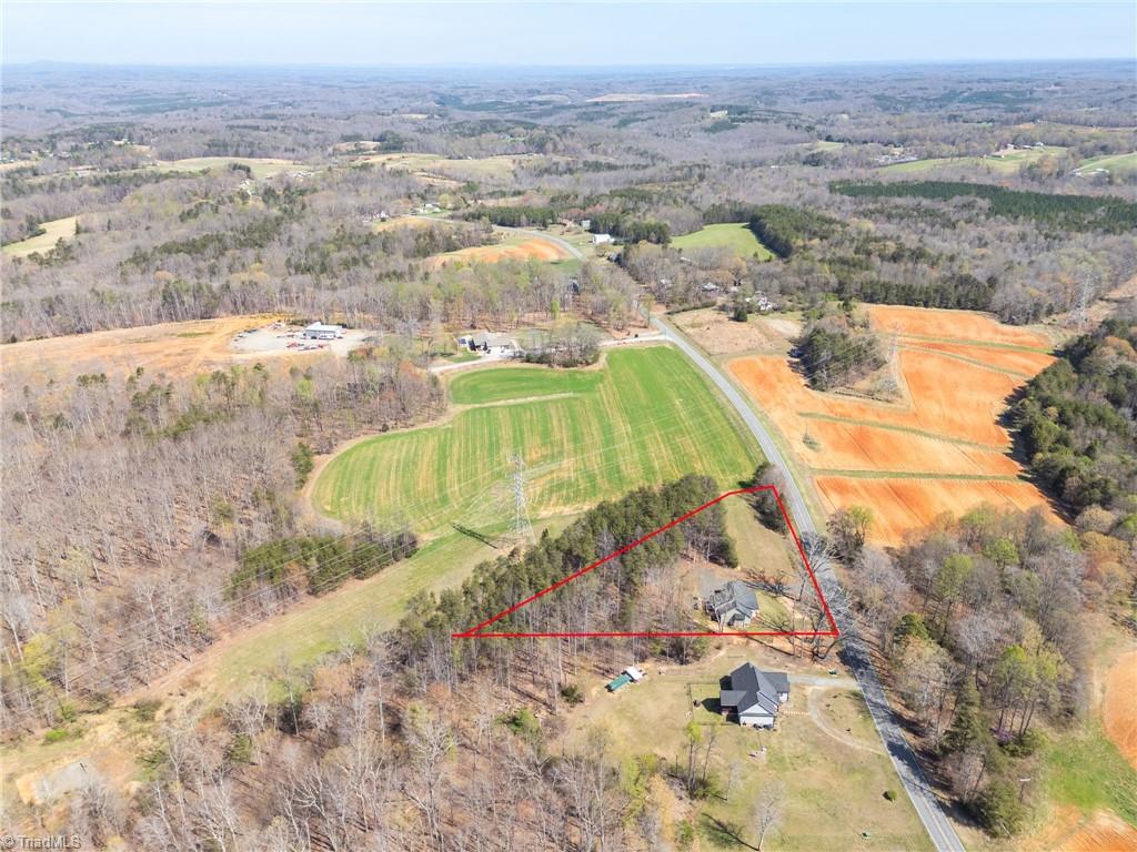 626 Bethany Road Reidsville, NC 27320 - Photo 40 of 42 Aerial view with lot lines at 626 Bethany Road, Reidsville, NC 27320, Rockingham County. Shows surrounding area including open fields, roads, and neighboring properties in the Bethany Community.