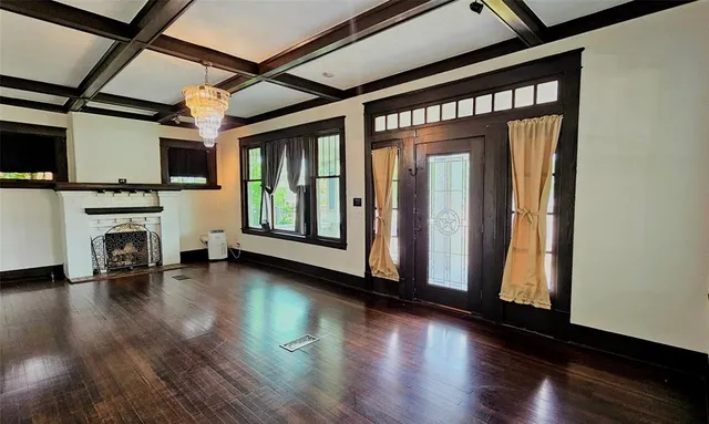 a view of a hallway with wooden floor and windows