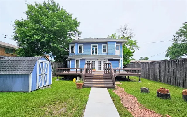a view of a house with a yard and furniture