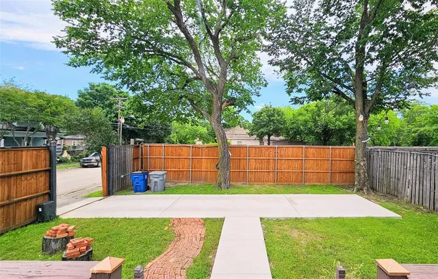 a view of backyard with wooden fence
