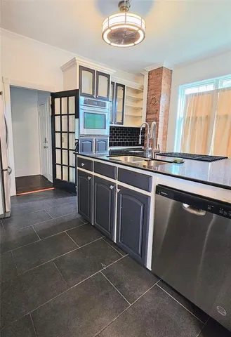 a kitchen with stainless steel appliances a sink and cabinets