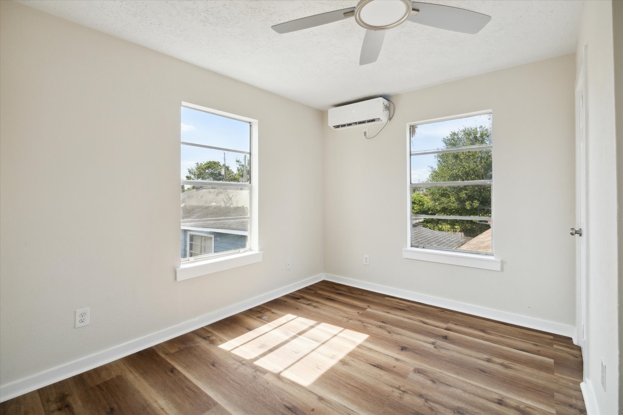 2802 Hardy Street, Unit C Houston, TX 77009 - Photo 16 of 18 a view of an empty room with wooden floor and a window