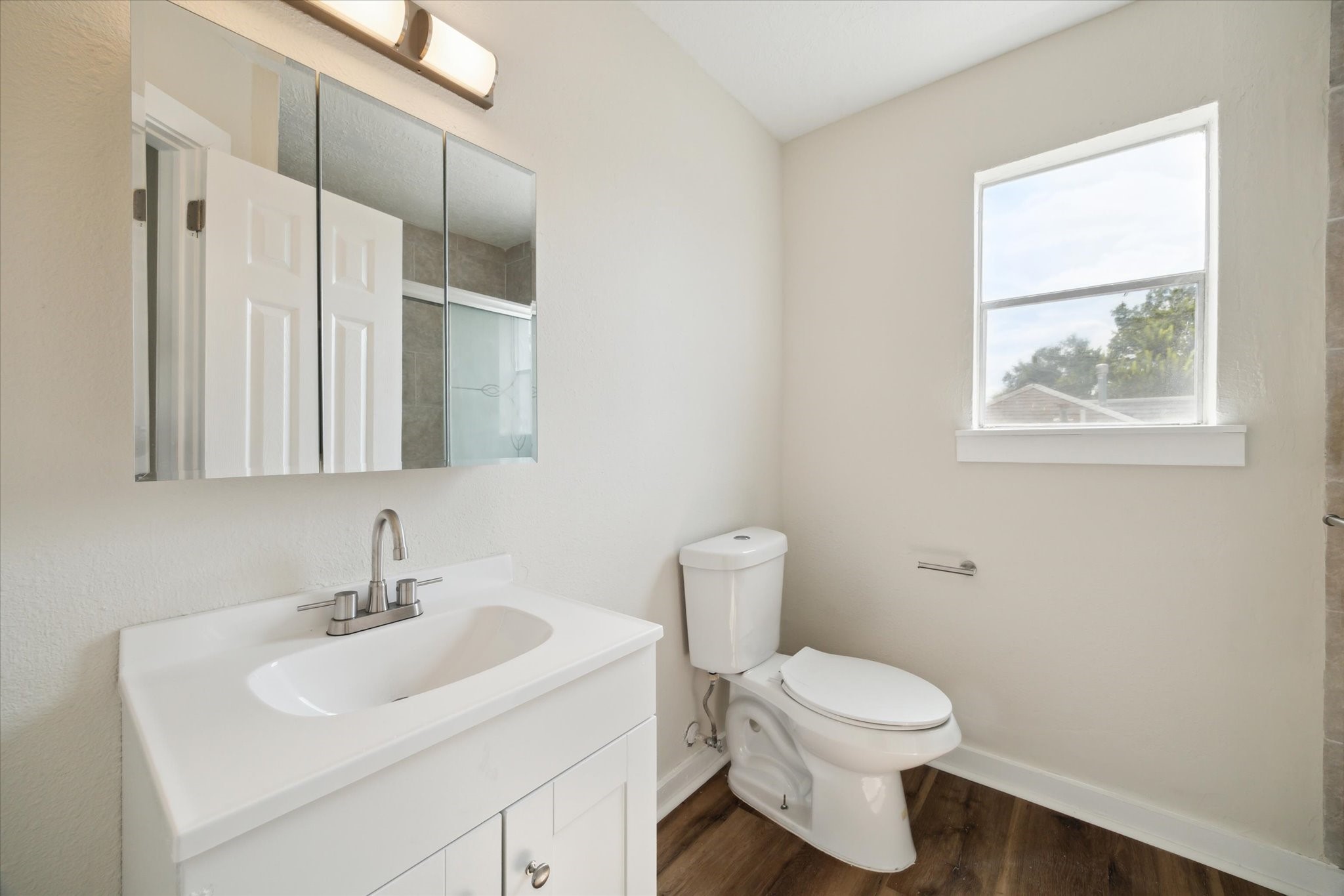 2802 Hardy Street, Unit C Houston, TX 77009 - Photo 17 of 18 a bathroom with a toilet sink and mirror
