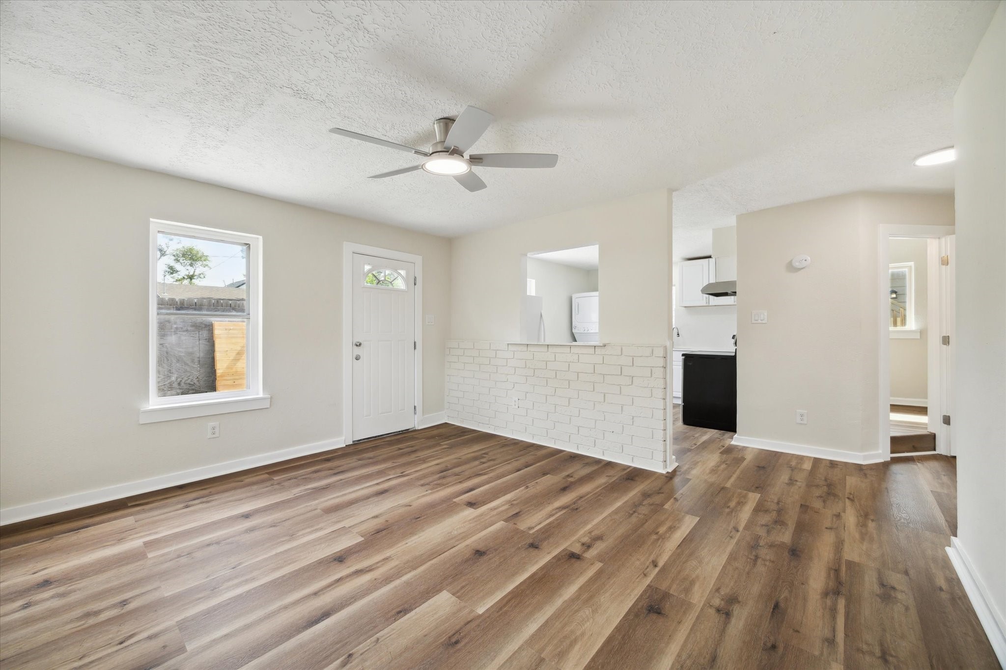 2802 Hardy Street, Unit C Houston, TX 77009 - Photo 5 of 18 a view of empty room with wooden floor and fan