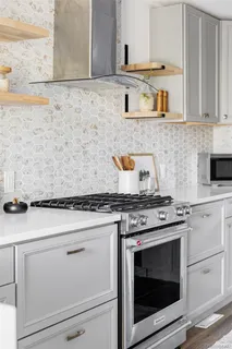 a stove top oven sitting inside of a kitchen