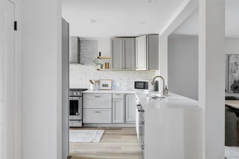 a kitchen with a sink cabinets and appliances