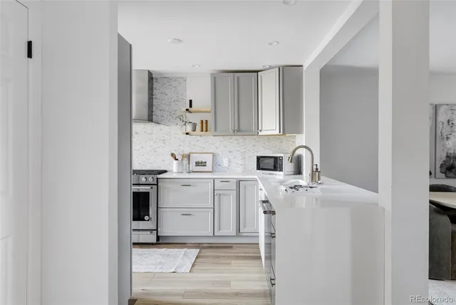 a kitchen with a sink cabinets and appliances