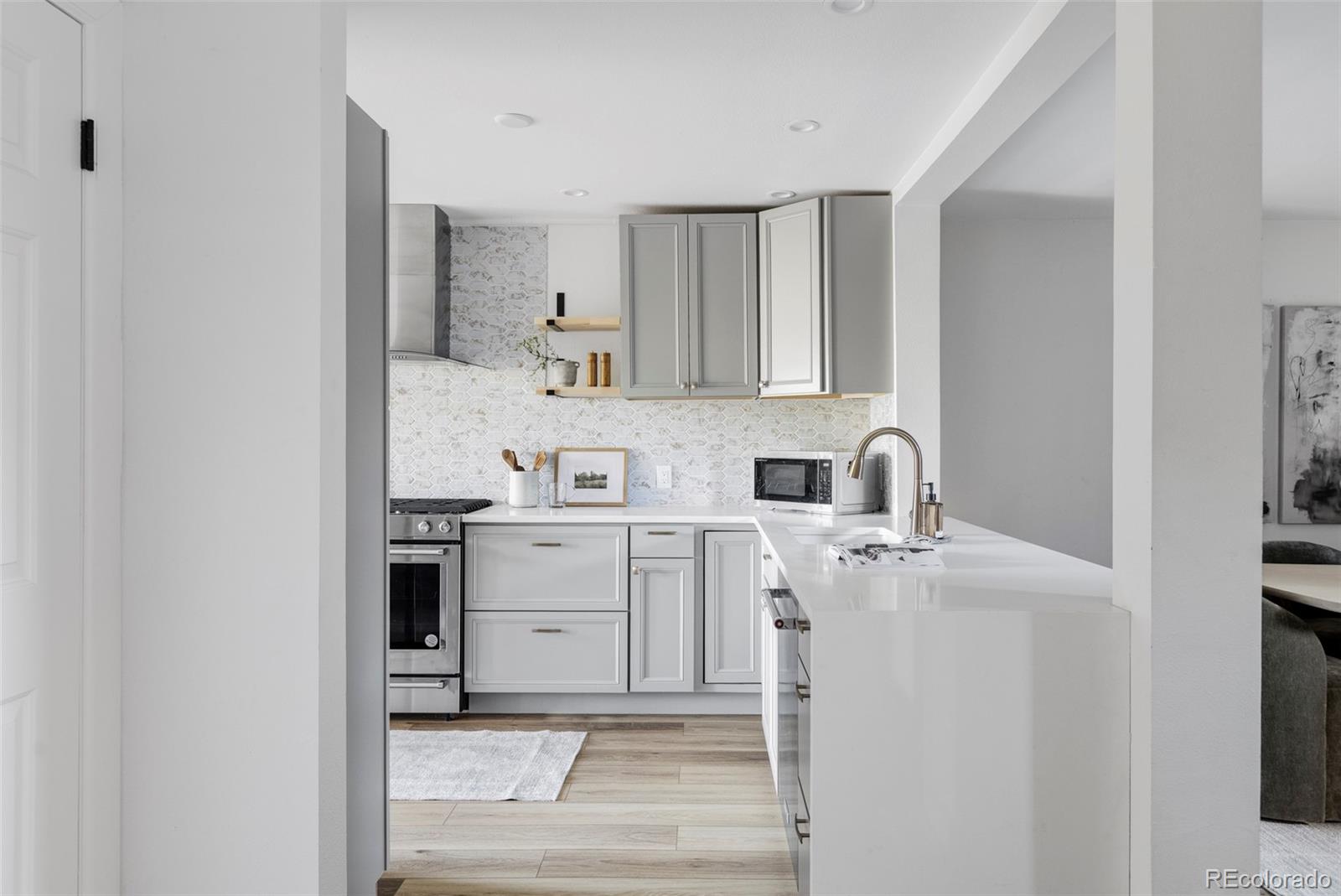 6000 West Mansfield Avenue, Unit 12 Denver, CO 80235 - Photo 12 of 41 a kitchen with a sink cabinets and appliances