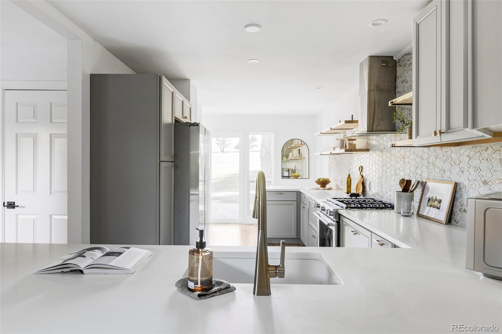 6000 West Mansfield Avenue, Unit 12 Denver, CO 80235 - Photo 14 of 41 a kitchen with granite countertop a sink appliances and cabinets