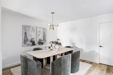 a view of a dining room with a table and chairs