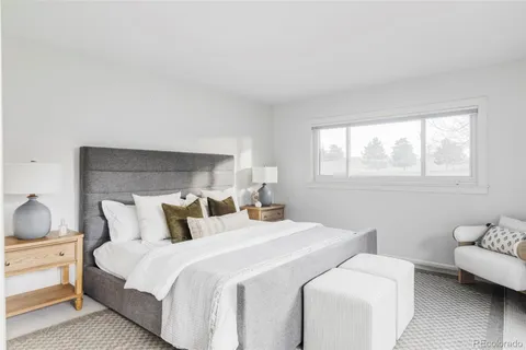 a bedroom with bed and a couch