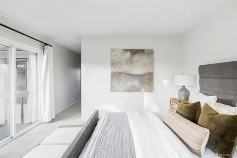 a view of a bedroom with furniture and wooden floor