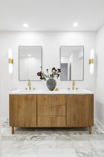 a bathroom with a sink mirror and vanity