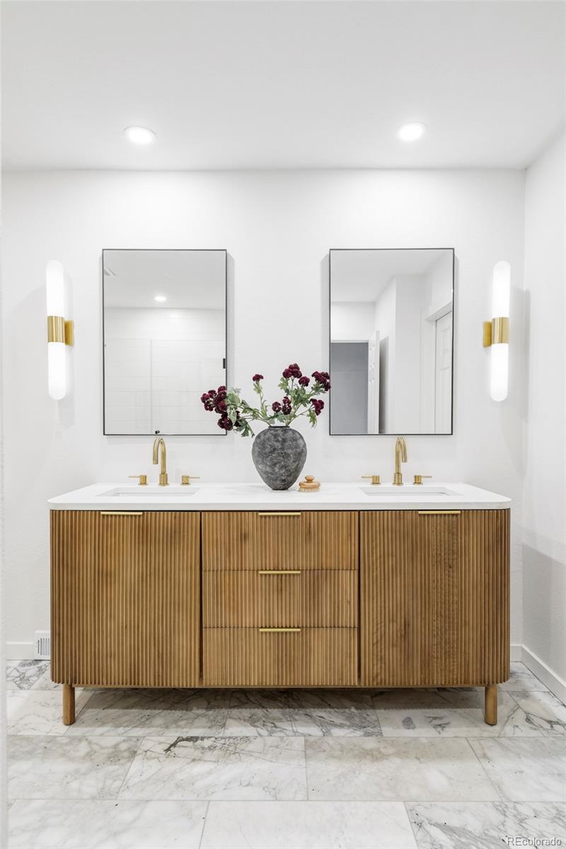 6000 West Mansfield Avenue, Unit 12 Denver, CO 80235 - Photo 22 of 41 a bathroom with a sink mirror and vanity