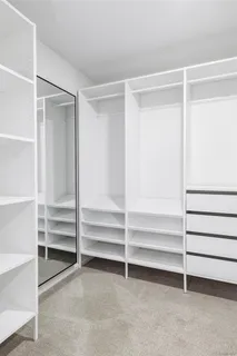 a view of walk in closet with empty racks