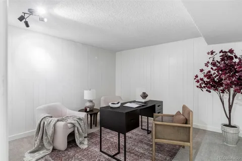 a living room with furniture and flowers