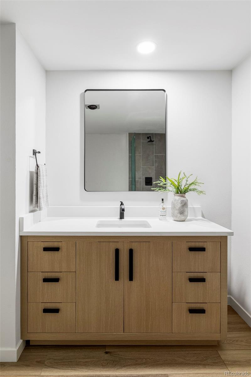 6000 West Mansfield Avenue, Unit 12 Denver, CO 80235 - Photo 28 of 41 a bathroom with a sink vanity and a mirror