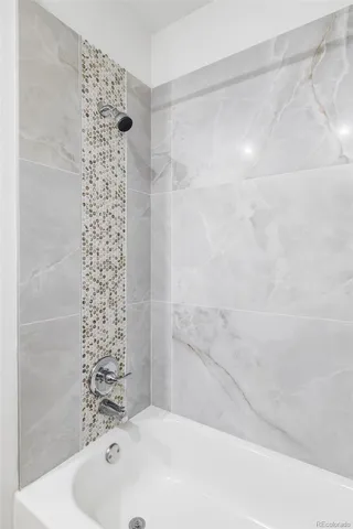 a bathroom with a bathtub and shower