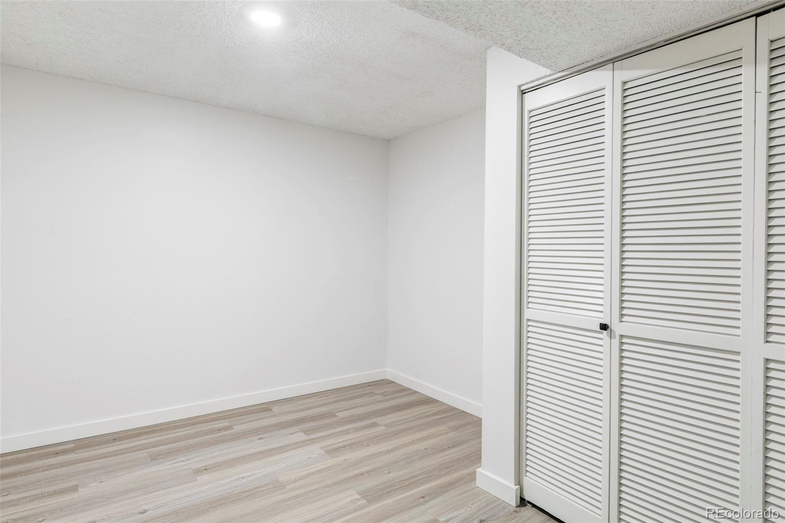 6000 West Mansfield Avenue, Unit 12 Denver, CO 80235 - Photo 33 of 41 a view of a small space with wooden floor and a window