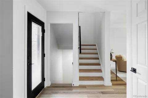 a view of a hallway with wooden floor and entryway