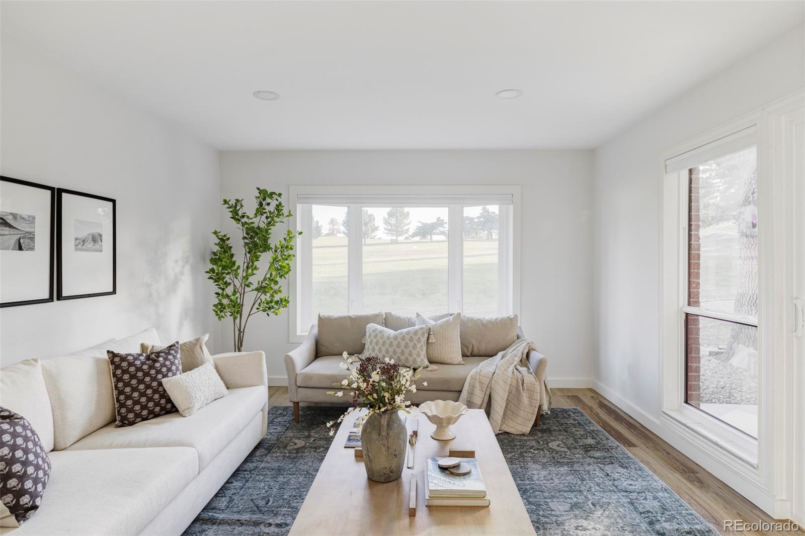 6000 West Mansfield Avenue, Unit 12 Denver, CO 80235 - Photo 6 of 41 a living room with furniture and a large window