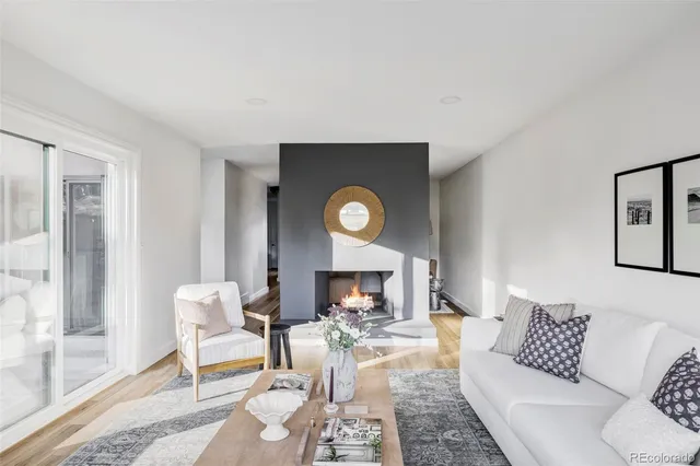 a living room with furniture a fireplace and a table