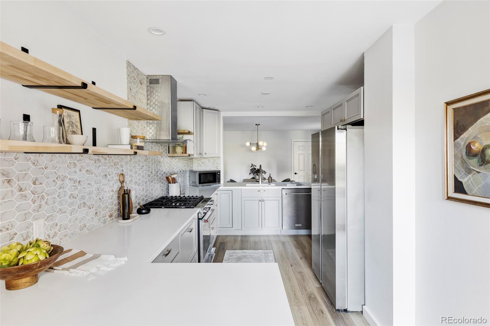 6000 West Mansfield Avenue, Unit 12 Denver, CO 80235 - Photo 10 of 41 a kitchen with cabinets and window
