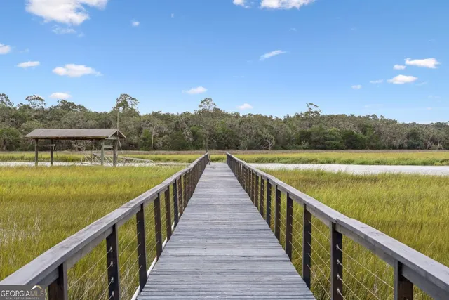 a living room with furniture fireplace and a large window