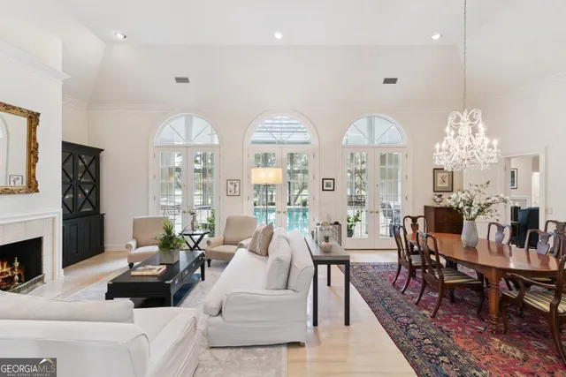 a living room with patio furniture and a chandelier