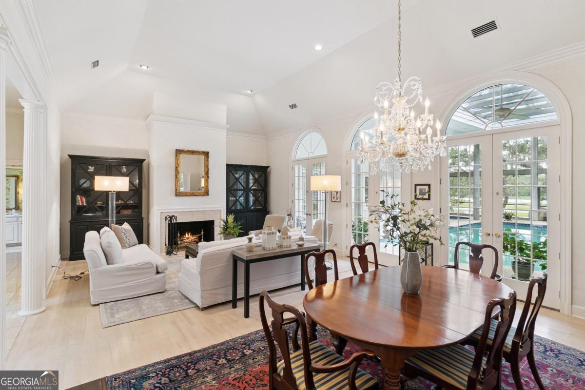 160 Hampton Point Drive St. Simons Island, GA 31522 - Photo 16 of 59 a living room with patio furniture and a chandelier