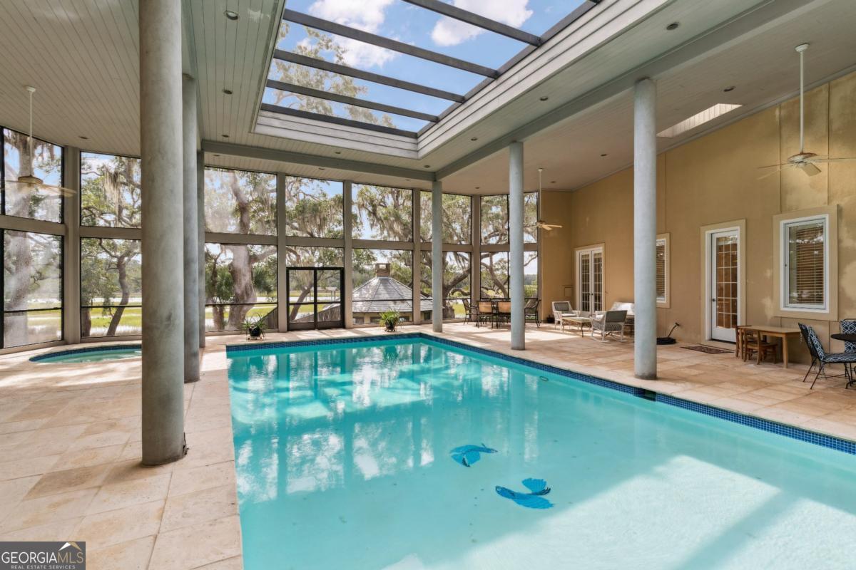160 Hampton Point Drive St. Simons Island, GA 31522 - Photo 30 of 59 a indoor swimming pool with outdoor seating
