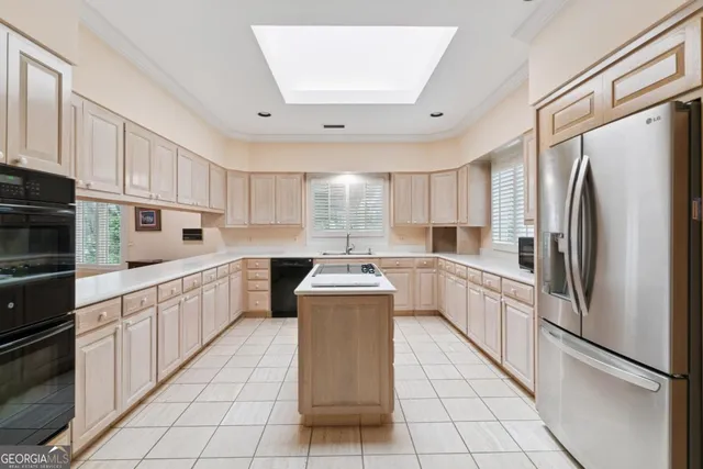 a living room with furniture and kitchen view