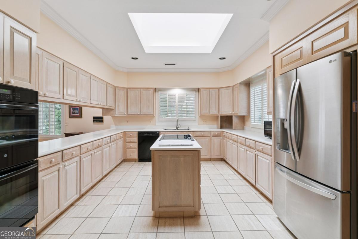 160 Hampton Point Drive St. Simons Island, GA 31522 - Photo 33 of 59 a kitchen with stainless steel appliances a refrigerator sink and cabinets