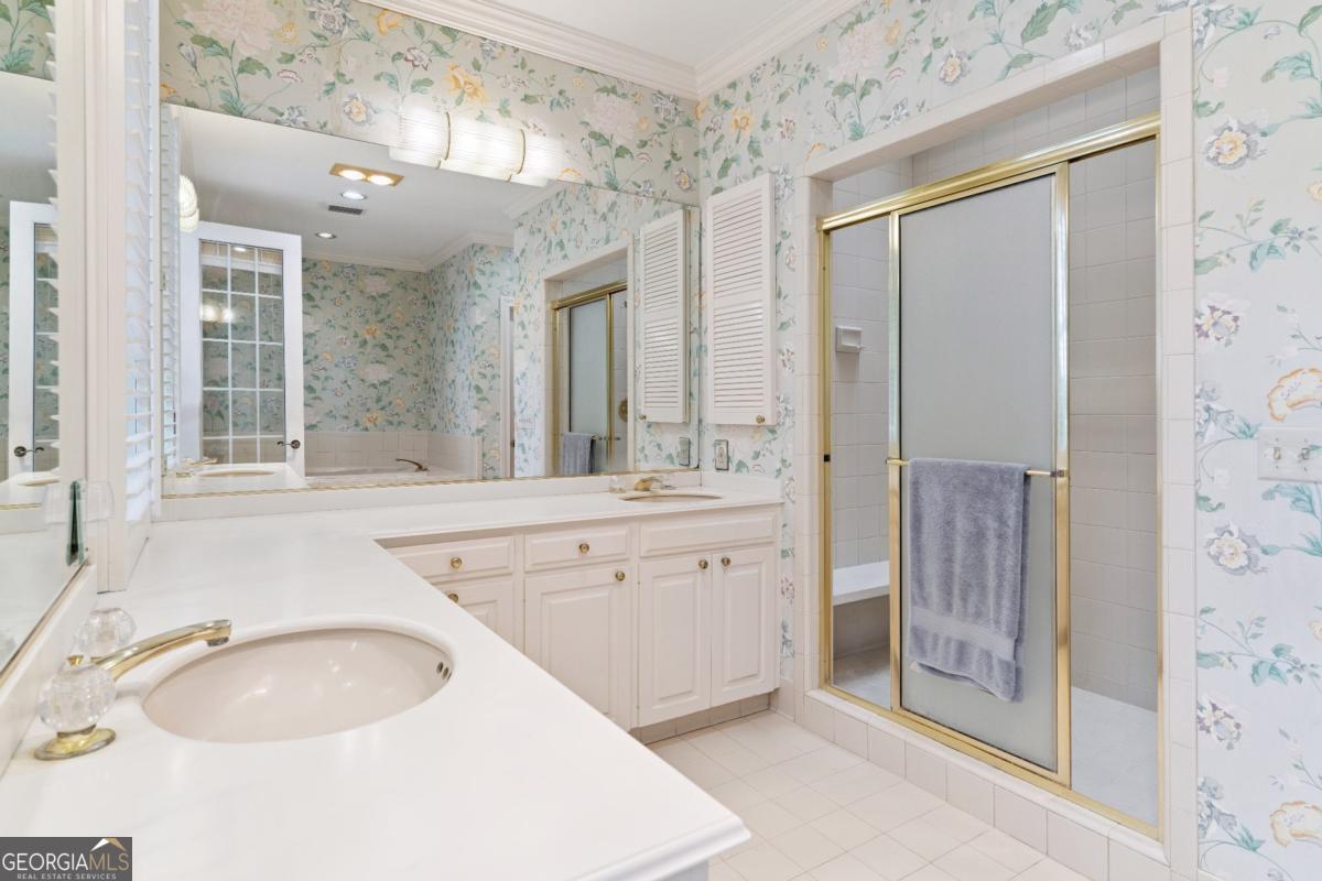 160 Hampton Point Drive St. Simons Island, GA 31522 - Photo 40 of 59 a spacious bathroom with a granite countertop sink mirror and shower
