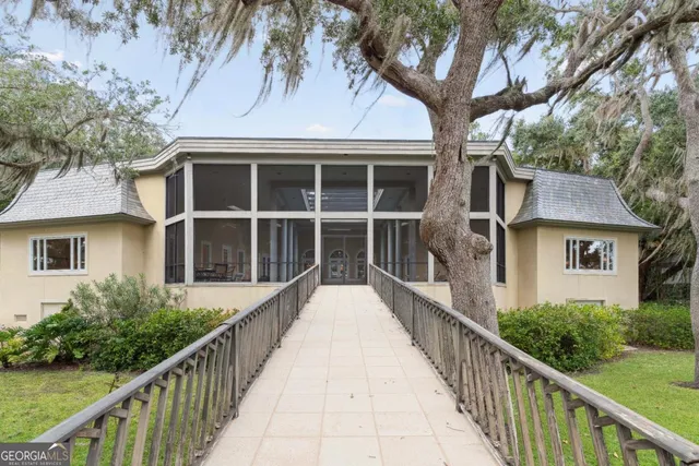 a living room with furniture a fireplace and a floor to ceiling window