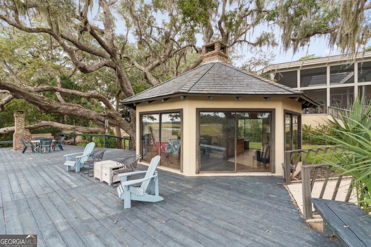 160 Hampton Point Drive St. Simons Island, GA 31522 - Photo 49 of 59 a view of a patio with table and chairs and wooden floor