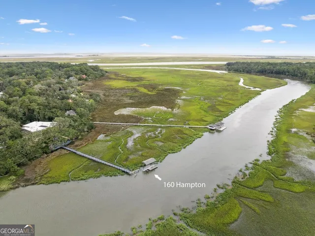 a view of a swimming pool with an outdoor seating space
