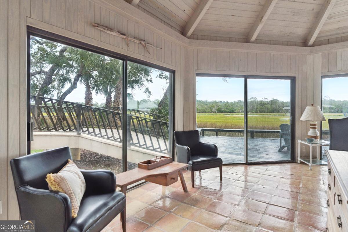 160 Hampton Point Drive St. Simons Island, GA 31522 - Photo 56 of 59 a living room with furniture tv and large windows