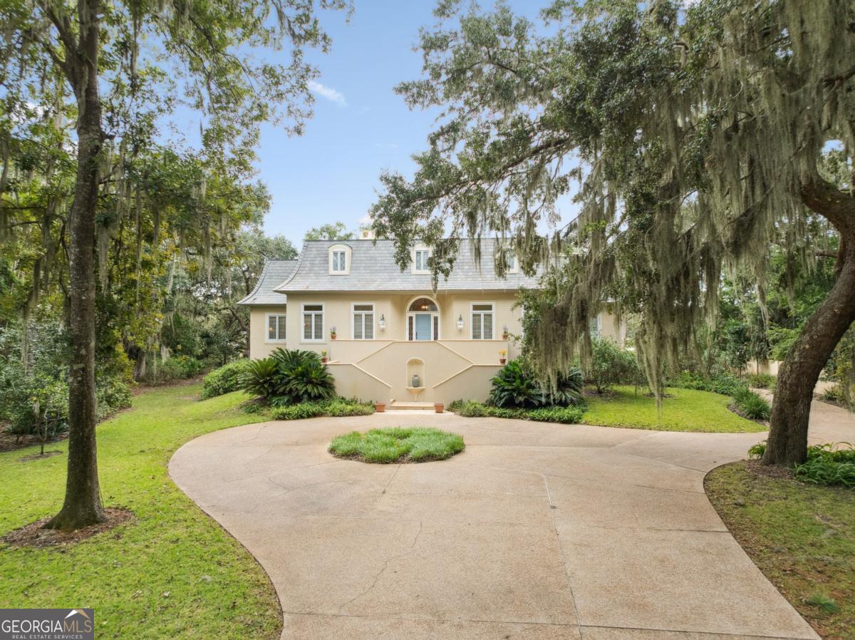 160 Hampton Point Drive St. Simons Island, GA 31522 - Photo 9 of 59 a front view of a house with a yard and green space