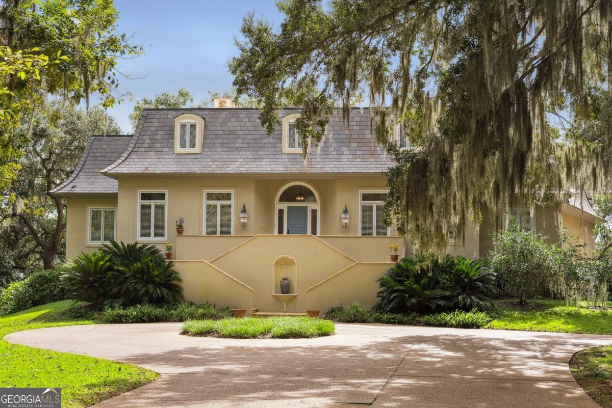 160 Hampton Point Drive St. Simons Island, GA 31522 - Photo 10 of 59 a front view of a house with a yard and garage