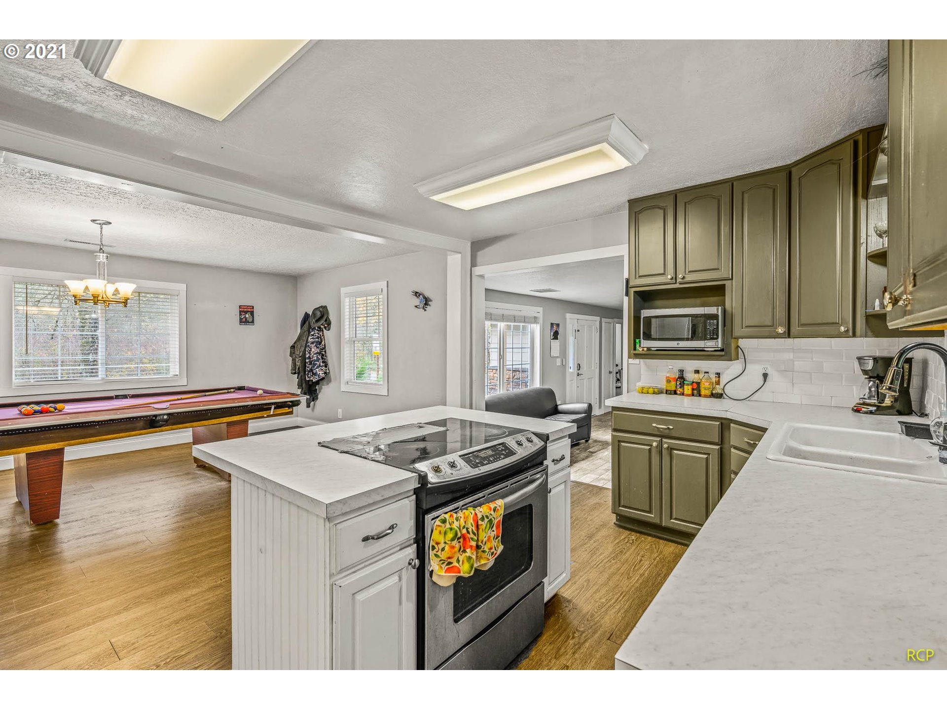 6732 Southeast Telford Road Gresham, OR 97080 - Photo 11 of 27 a kitchen that has a sink and a stove in it