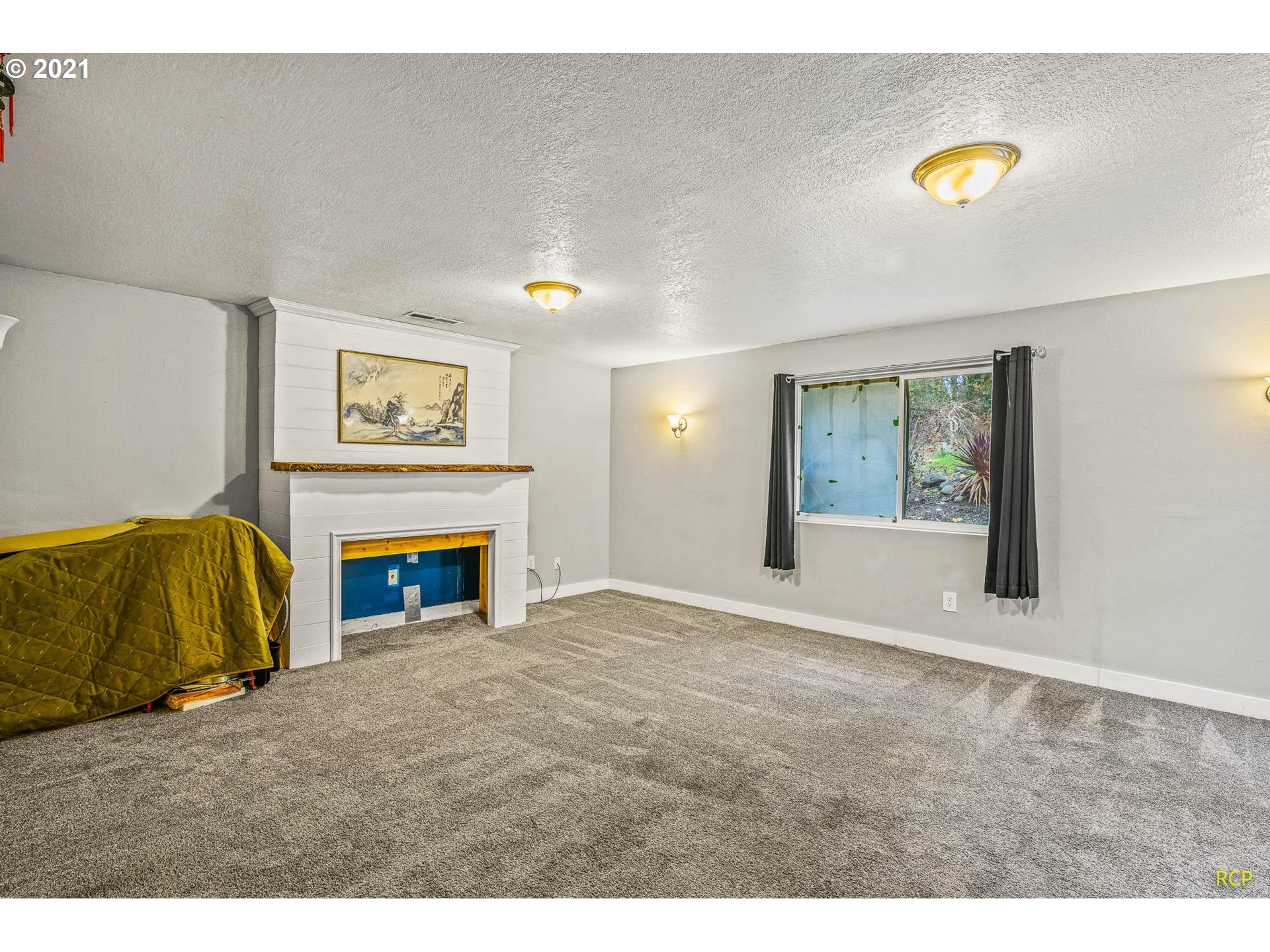 6732 Southeast Telford Road Gresham, OR 97080 - Photo 17 of 27 a view of an empty room with a fireplace and a window