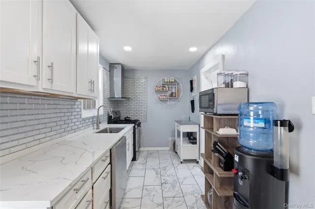 a kitchen with a sink a stove and refrigerator