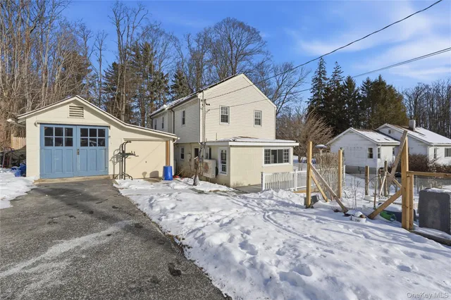 a view of a house with a yard covered in snow